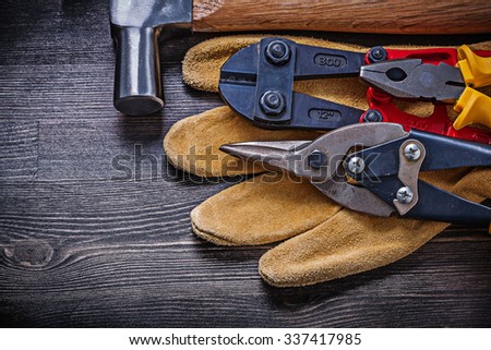 Leather working gloves pliers steel cutter tin snips claw hammer.
