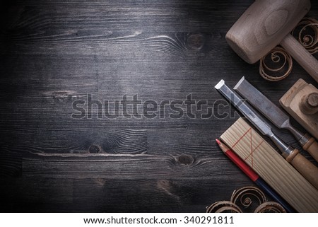 Flat chisels planer wood shavings pencil wooden plank mallet copyspace.
