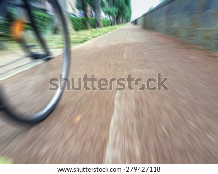 Ecological commuting. \
Cycling from train station to workplace on the bike lane. Motion blurred image due to the motion.