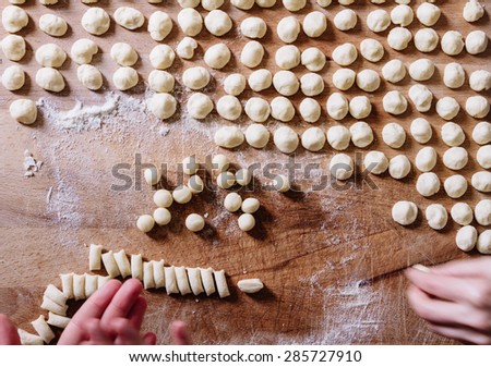 Young adult girl cooking Italian handmade pasta, Orecchiette.\
Traditional dish of the southern region of Italy.