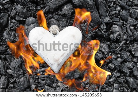 a wooden heart in flames