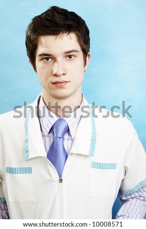 young handsome caucasian doctor wearing smock