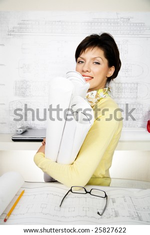 young female engineer with blueprints in the office