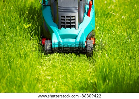 Mowing the lawn with new modern mower