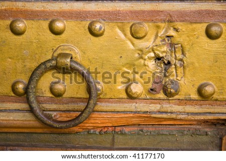 medieval copper door handle with ring and copper studs and weathered wood