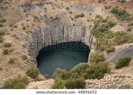 big hole in kimberley, south africa, where De Beers diamond company originated and diamonds were dug out by hand. Largest man made hole on earth
