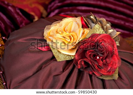 purple silk pillow with yellow and red roses