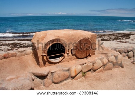 old fashioned clay outdoor oven at the seaside for baking bread with a wood fire