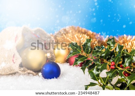 Christmas balls and Santa`s pack on the snow.