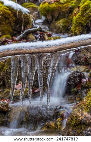 Mountain stream with waterfalls with icicle in forests of Slovakia