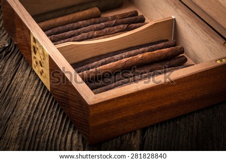 humidor with quality cigar on an old wooden table