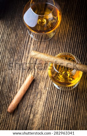 quality cigars and cognac on an old wooden table