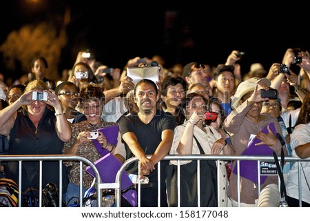 LOS ANGELES, CALIFORNIA/USA - OCTOBER 13, 2012: (Night) Crowd welcomes NASA Space Shuttle Endeavour as it\'s transported through neighborhood streets, October 13, 2012 in Los Angeles, California, USA.