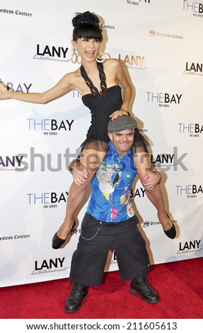 LOS ANGELES/CALIFORNIA - AUGUST 4, 2014: Bai Ling & Sammy The Dwarf pose on the red carpet at \