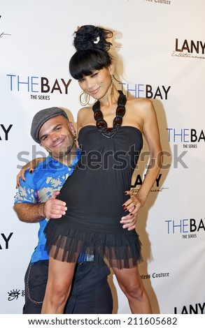 LOS ANGELES/CALIFORNIA - AUGUST 4, 2014: Bai Ling & Sammy The Dwarf pose on the red carpet at \