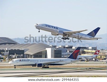 LOS ANGELES/CALIFORNIA - JULY 12, 2015: United Airlines Boeing 777 departs as Delta Airlines Boeing 767 arrives at Los Angeles International Airport in Los Angeles, California, USA