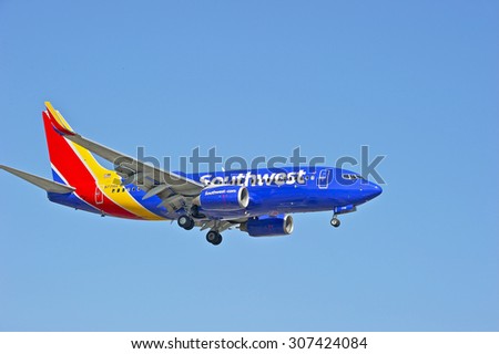SANTA ANA/CALIFORNIA - AUG. 17, 2015: Southwest Airlines Boeing 737-700 commercial jet approaches runway to make a landing at John Wayne International Airport in Santa Ana, California, USA