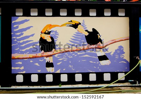 PHITSANULOK - AUGUST 7: Colorful graffiti of hornbill on the wall by an unidentified artist on August 7, 2013 in Phitsanulok, Thailand.