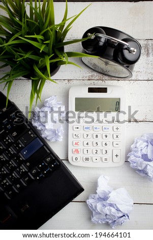 Top view of office table with calculator and computer