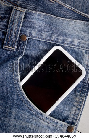 Close up of smart phone in pocket jeans