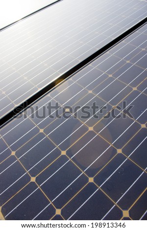 Close up of dirty solar panels with light flare