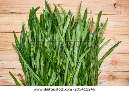 Water spinach on wooden background