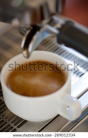 Close up of a cup of coffee making from espresso coffee machine