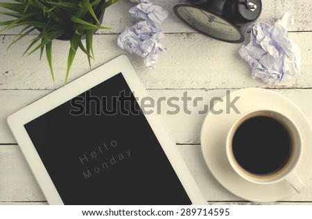 Hello Monday - Text on top view of tablet on office table with vintage effect