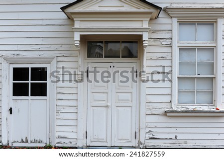 wooden door and window in an cream wall