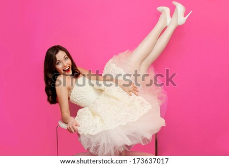 Beautiful girl in white dress having fun on the table. Holiday, wedding, shopping, pin up - concept