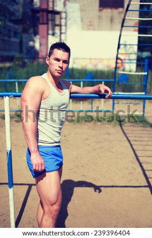 Street workout, handsome sporty man doing training outdoors