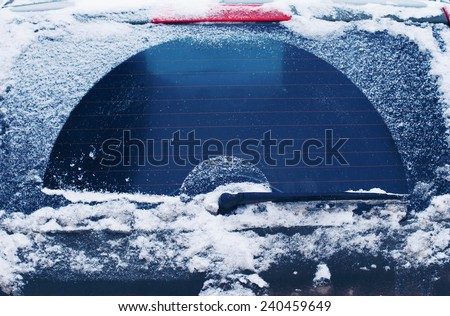 Winter frozen back car window, texture freezing ice glass background