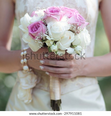 Gentle wedding bouquet of flowers in hands elegant bride