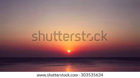 Scenic landscape view of the sea with a beautiful evening sunset, the sun sets beyond the horizon, travel photo