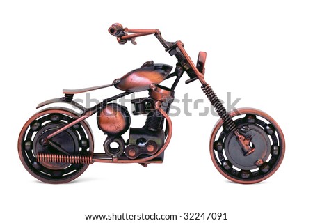 Handmade model of custom motorcycle. Bronze scale model of chopper. Side view. Isolated on white