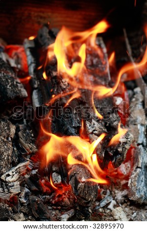 Home fireplace. Red fire and black ash abstract background