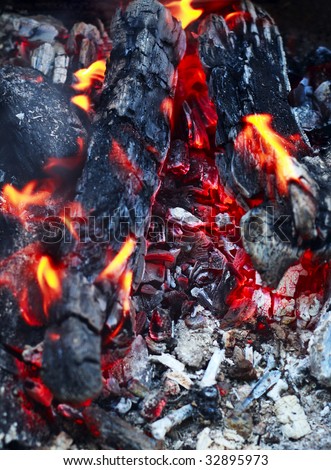 Home fireplace. Red fire and black ash abstract background