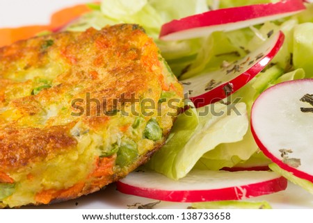 Part of vegetable burger with salad