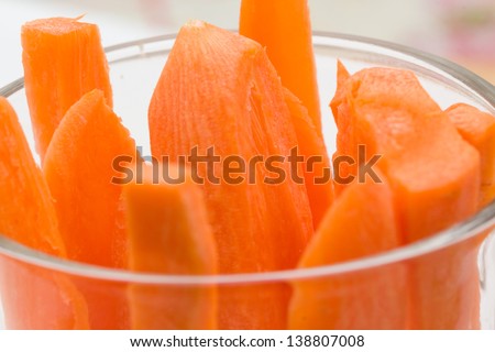 Macro of sliced fresh carrots in clear glass