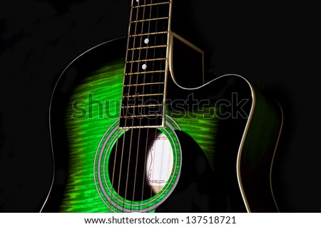 green acoustic guitar body.sunburst.black background