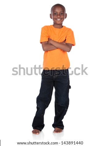 Cute african boy wearing a bright orange t-shirt and dark denim jeans. The boy is standing and smiling at the camera.