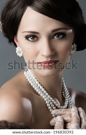 Beautiful young caucasian girl wearing vintage clothing accessories and jewelry.