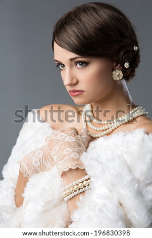 Beautiful young caucasian girl wearing vintage clothing accessories and jewelry.