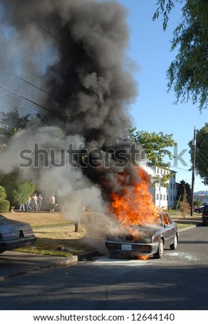 A car is burning on the street. The story of a firefighter putting out the fire.