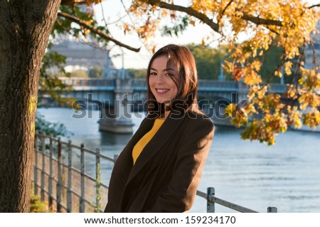 Beautiful young woman in Paris on a sunny autumn day