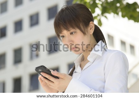 A sad or anxious woman falls to look at the mobile phone