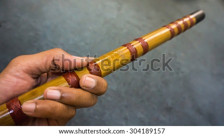 Bamboo flute and hand isolated on white background