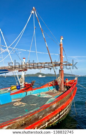 The red fishing boat and blue sea.