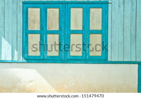 Blue-white wood window and soft sunshine in the morning