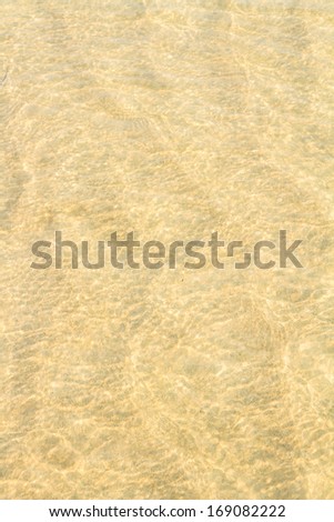 Crystal clear water on gold sand of sea